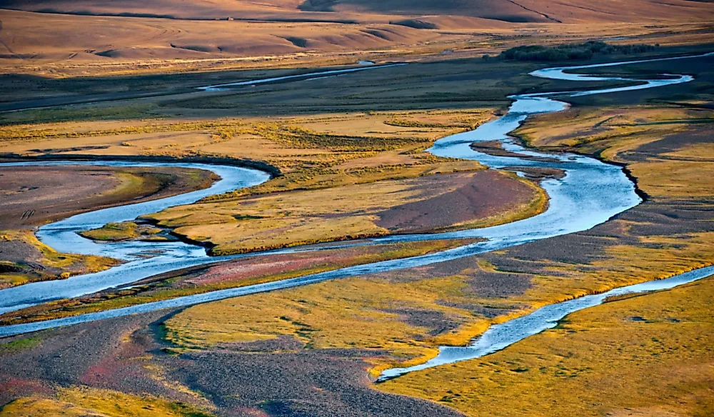 A winding blue river through open grassland.